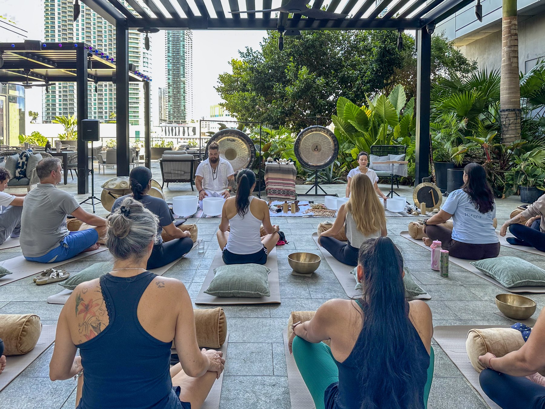 Participants seated in a circle around the gongs as the session begins
