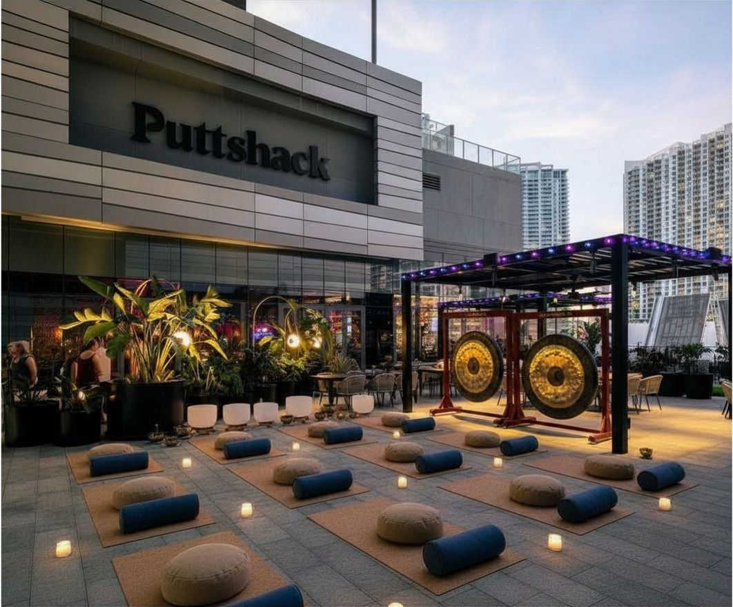 Rendering of the Puttshack terrace laid out with mats, bolsters and singing bowls at dusk
